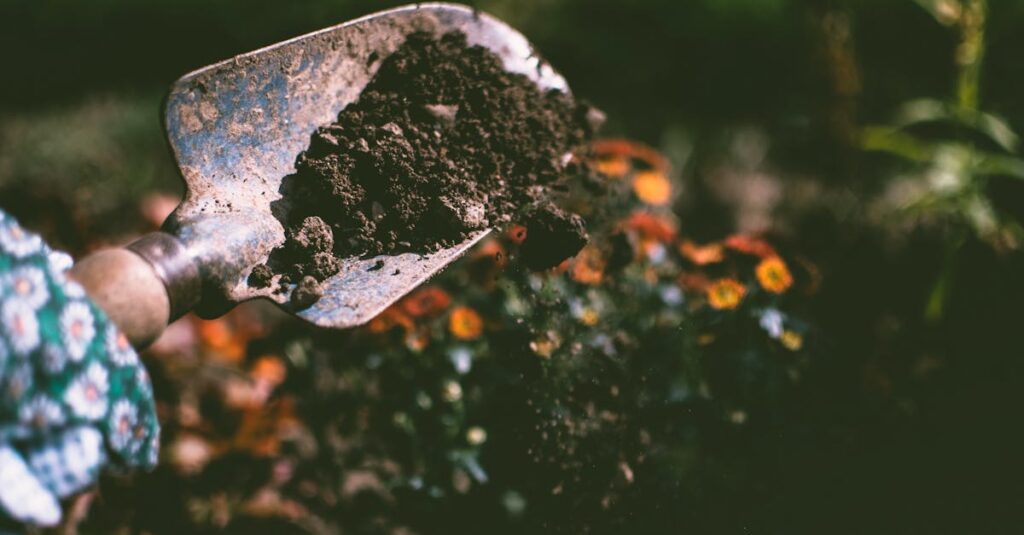 Person Digging on Soil Using Garden Shovel